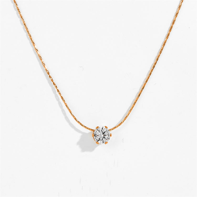 Gold-tone six claw pendant necklace with clear stone pendant, close-up view