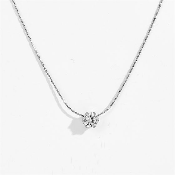 Silver-tone six claw pendant necklace with clear stone pendant, close-up view