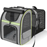 Grey expandable pet carrier backpack with green trim and mesh ventilation panels