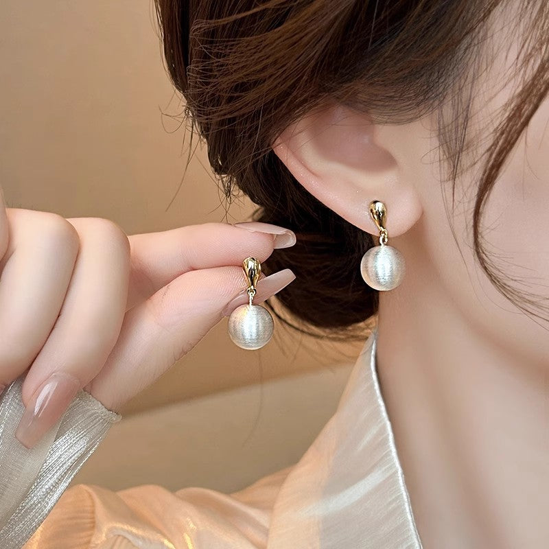 Frosted brushed ball stud earrings, close-up of the frosted ball drop finish