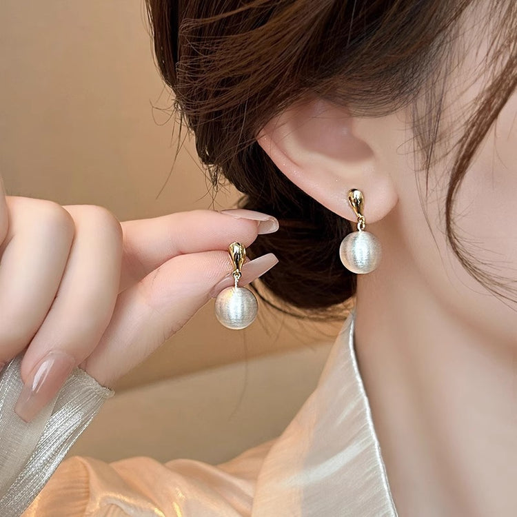Frosted brushed ball stud earrings, close-up of the frosted ball drop finish