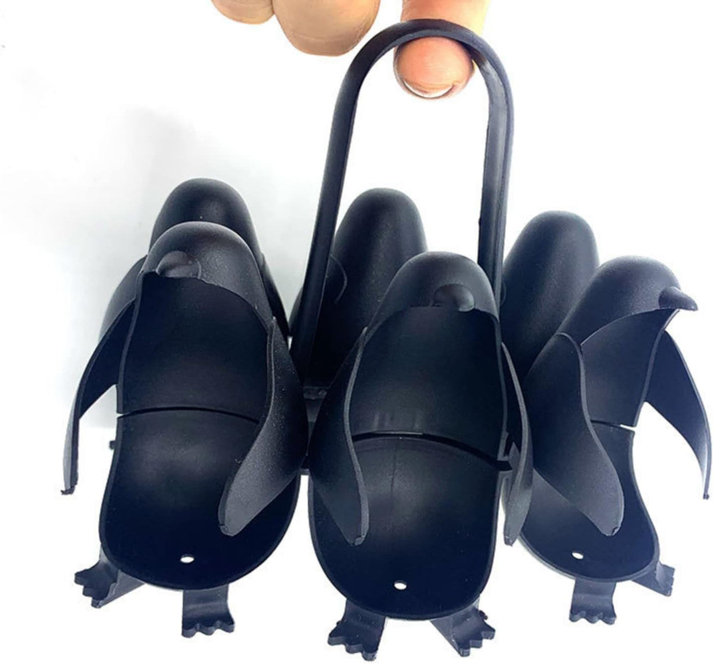 Close-up of penguin egg holder pieces showing the center handle and feet
