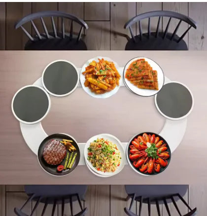 White ring-shaped rotating serving tray holding six round dishes evenly spaced for independent spinning